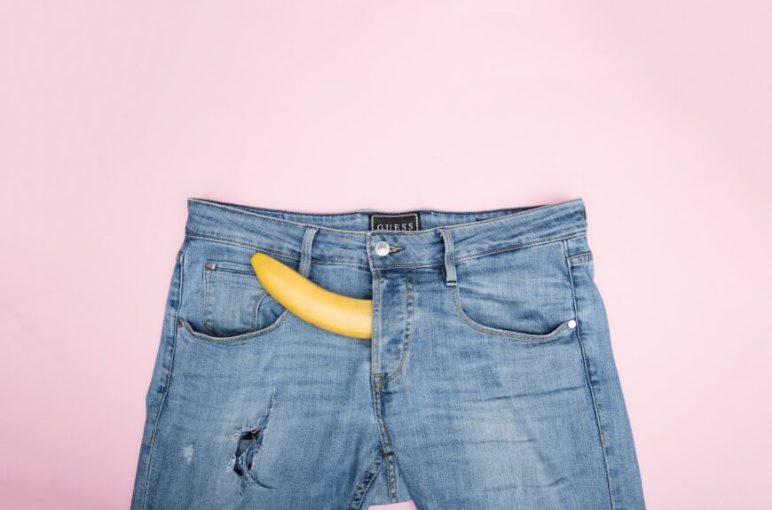 blue denim jeans on white textile with a banana